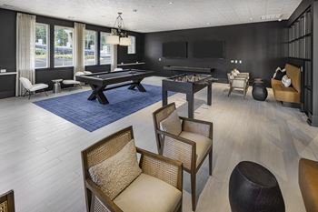A room with a pool table and a television