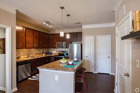 Smyrna apartment for rent - a kitchen with an island and a stainless steel refrigerator at Grand Oak at Town Park, Smyrna, Tennessee