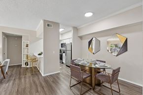 St. Petersburg apartment for rent - A dining room with a table set for two and a kitchen in the background.
