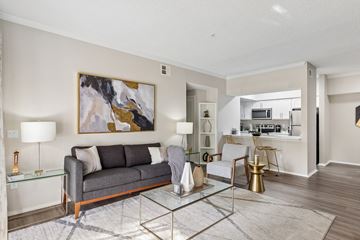 St. Petersburg apartment for rent - A modern living room with a grey sofa and a glass coffee table.