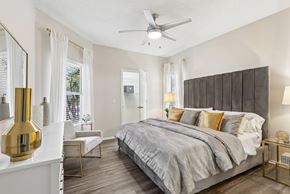 St. Petersburg apartment for rent - A bedroom with a large bed and a ceiling fan.