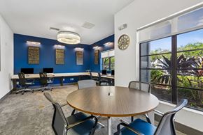 Tampa apartment for rent - A conference room with a table, chairs, and a view of the outdoors.