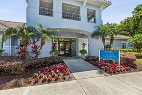 Tampa apartment for rent - A white building with a sign that says "Clubhouse and Pool".
