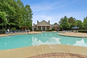Lawrenceville apartment for rent - A large swimming pool with a house in the background.
