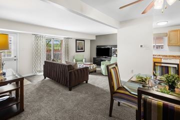 Carneys Point apartment for rent - A living room with a brown couch and a striped chair.