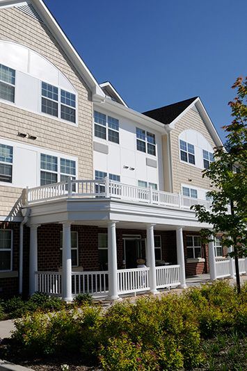 Randallstown apartment for rent - A house with a white porch and a black roof.