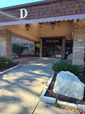 Coon Rapids apartment for rent - the front entrance of a building with a white awning