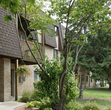 Forest Lake townhouse for rent - a building with a tree in front of it