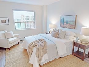London apartment for rent - A bedroom with a large bed and a painting on the wall.