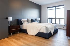 London apartment for rent - a bedroom with a bed and a wood floor