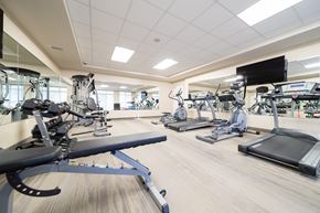 London apartment for rent - A gym with treadmills, elliptical machines, and other cardio equipment.