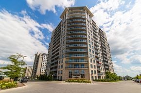 London apartment for rent - A tall residential building with a parking lot in front.
