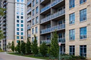 London apartment for rent - an apartment building with balconies and trees in front of a street