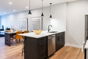 London apartment for rent - a kitchen with an island and a dining room with a table