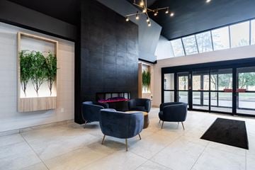 London apartment for rent - a living room with blue chairs and a fireplace
