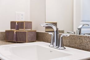 London apartment for rent - A modern bathroom with a white sink and a silver faucet.