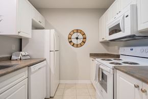 London apartment for rent - a kitchen with white appliances and a clock on the wall