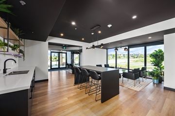 London apartment for rent - A modern kitchen with a bar area and a view of the outdoors.