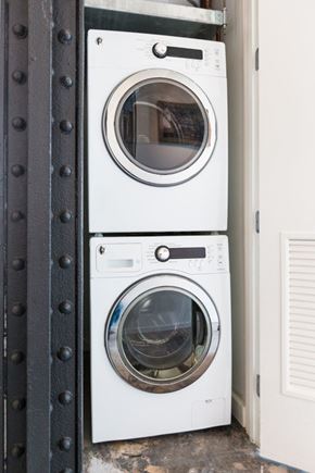 New Orleans apartment for rent - Two white front loading washing machines stacked on top of each other.