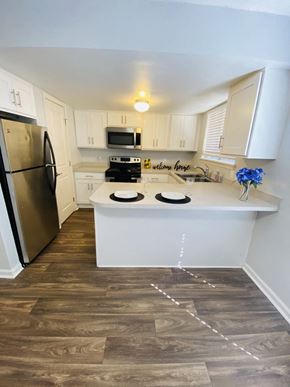 Lafayette apartment for rent - a kitchen with white cabinets and stainless steel appliances