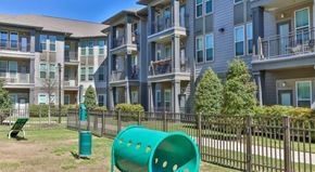 Baton Rouge apartment for rent - an apartment building with a green playground in front of it