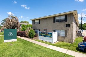 Lafayette apartment for rent - A Lila Place sign is in front of a brick building.