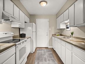 Lafayette apartment for rent - A kitchen with white appliances and cabinets.