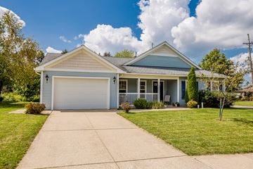 Edinboro apartment for rent - a blue house with a white garage door and a lawn