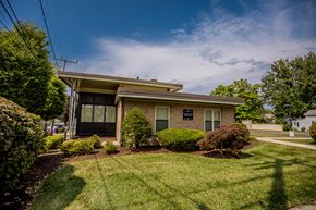 Erie apartment for rent - a small brick house with a lawn and bushes
