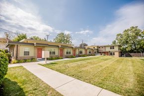 Erie apartment for rent - a row of houses with a lawn and sidewalk