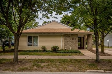 Erie apartment for rent - the front of a tan house with trees