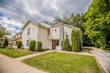 Meadville apartment for rent - a white house with a yard and a sidewalk