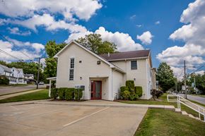 Meadville apartment for rent - a white house with a driveway and a parking lot