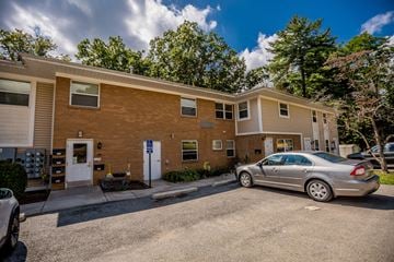 Meadville apartment for rent - a brick apartment building with a car parked outside