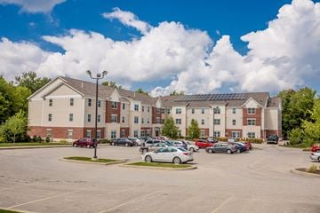 Edinboro apartment for rent - a parking lot with cars in front of an apartment building