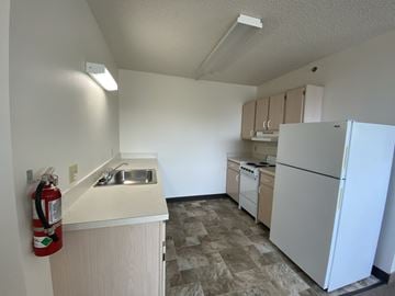 Erie apartment for rent - a kitchen with white appliances and a refrigerator and a sink