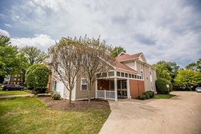 Erie apartment for rent - the front of a house with a porch and a driveway