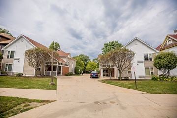 Erie apartment for rent - a street with white houses and a blue car parked in the driveway
