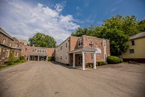 Erie apartment for rent - an empty parking lot in front of a brick building