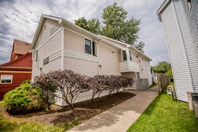 Erie apartment for rent - a white house with a sidewalk in front of it