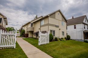 Erie apartment for rent - a house with a white picket fence and a sidewalk