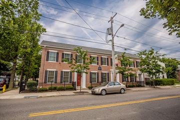 Erie apartment for rent - a red brick building with a silver car parked in front of it