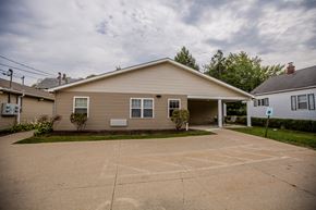 Erie apartment for rent - a tan house with a driveway in front of it