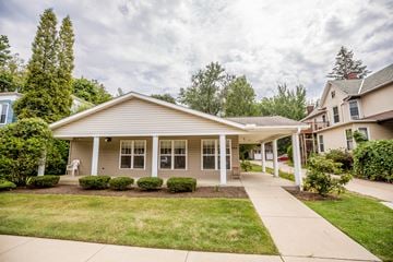 Erie apartment for rent - a small white house with a sidewalk in front of it
