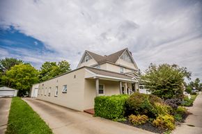 Corry apartment for rent - a cream colored house with a street in front of it