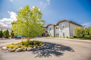 Mckean apartment for rent - an empty parking lot with a tree in front of a building