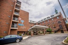Erie apartment for rent - a car is parked in front of a brick building