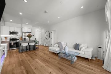 Chatsworth apartment for rent - A modern living room with a white sofa and wooden flooring.