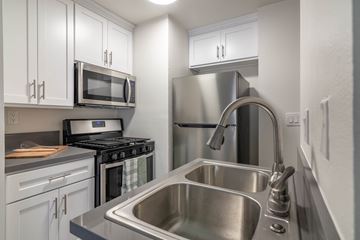 Los Angeles apartment for rent - A modern kitchen with a stainless steel sink and refrigerator.