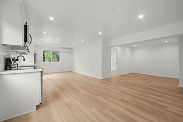 Los Angeles apartment for rent - A kitchen with white cabinets and a wooden floor.